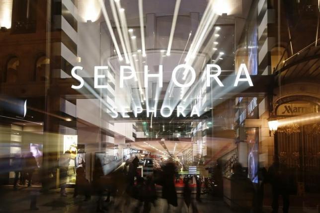 People walk out of the Sephora store on the Champs Elysees Avenue in Paris